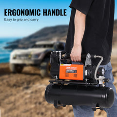 Man holding orange 150 PSI air compressor with black 6L tank and ergonomic handle outdoors near a car.