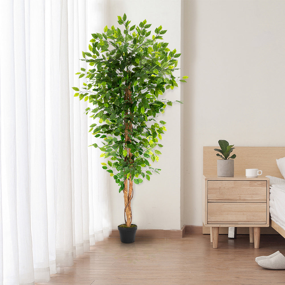 A 6-foot artificial banyan tree with a solid wood trunk and 1260 green leaves in a bedroom.