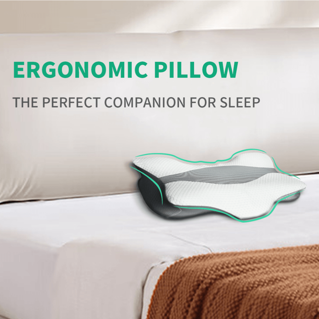 White ergonomic memory foam neck pillow with contoured support on a bed.