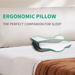 White ergonomic memory foam neck pillow with contoured support on a bed.