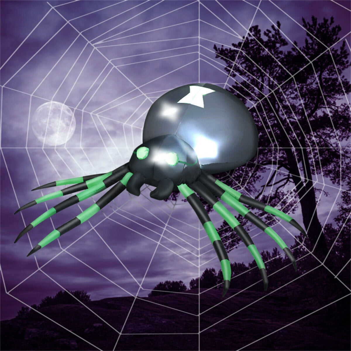 A large black inflatable spider with green striped legs and glowing eyes hangs on a web.