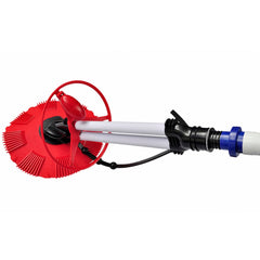 Red automatic pool bottom cleaner with white poles and blue hoses attached.
