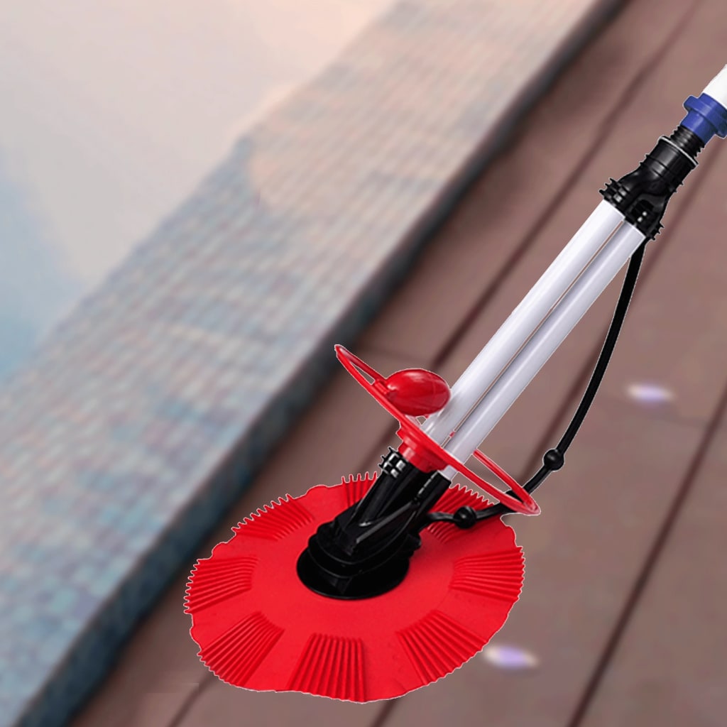 Red automatic pool bottom cleaner with white pole and hoses on pool deck.
