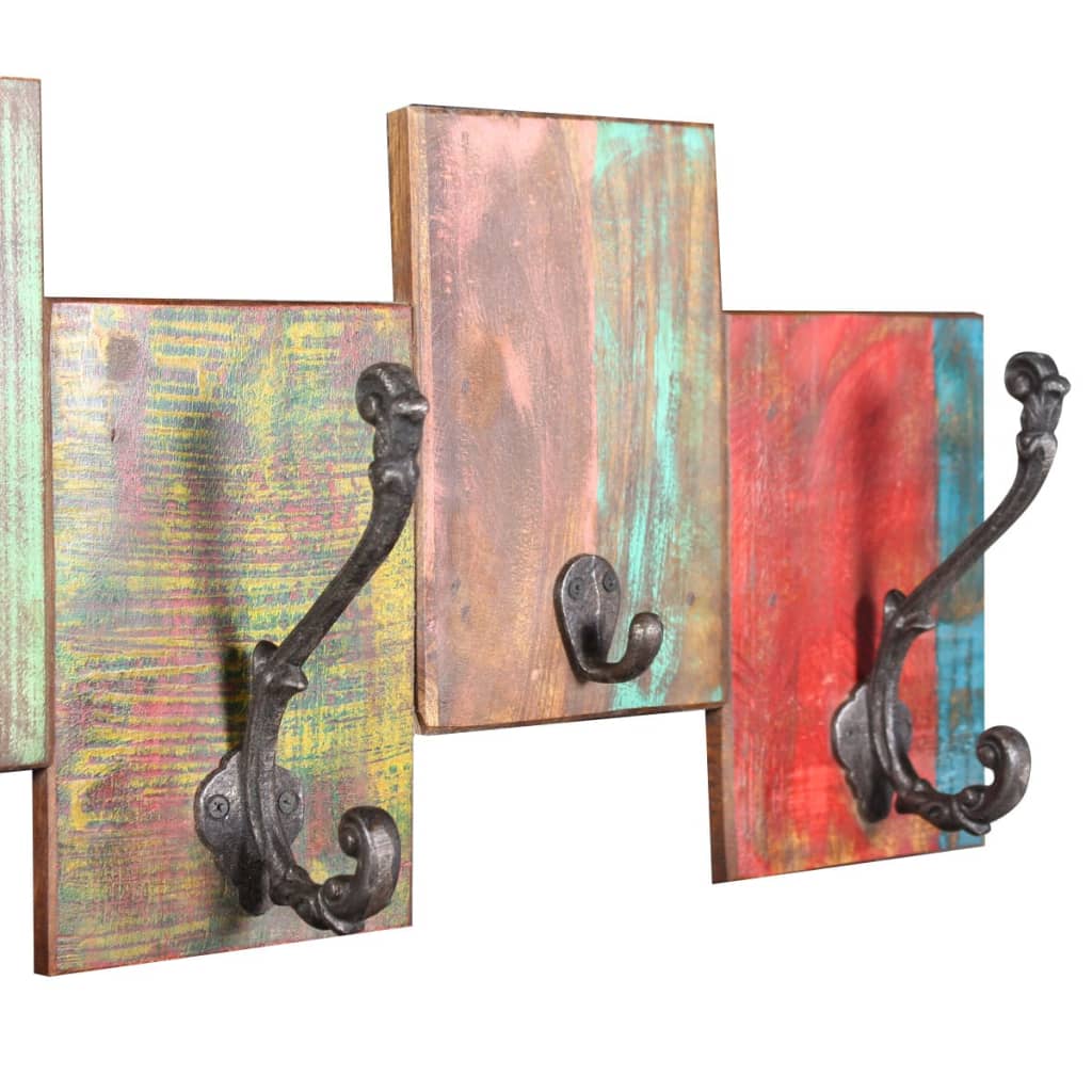 A vintage-style coat rack with seven metal hooks on colorful reclaimed wood panels.