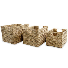 Three brown water hyacinth storage baskets of varying sizes with handles.