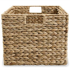 Set of three brown water hyacinth storage baskets in graduated sizes.