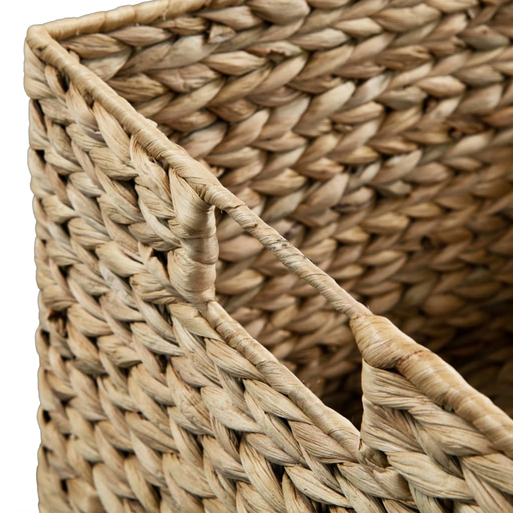Set of three brown water hyacinth storage baskets in graduated sizes.