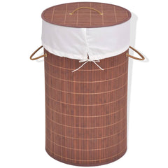 Brown round bamboo laundry hamper with white liner and handles.