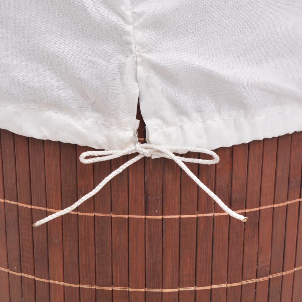 Brown bamboo round laundry hamper with white drawstring liner.