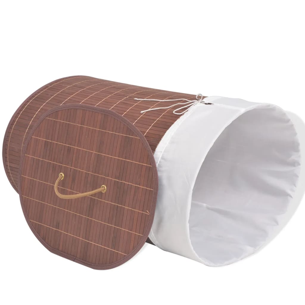 Oval brown bamboo laundry hamper with removable white liner and side handles.