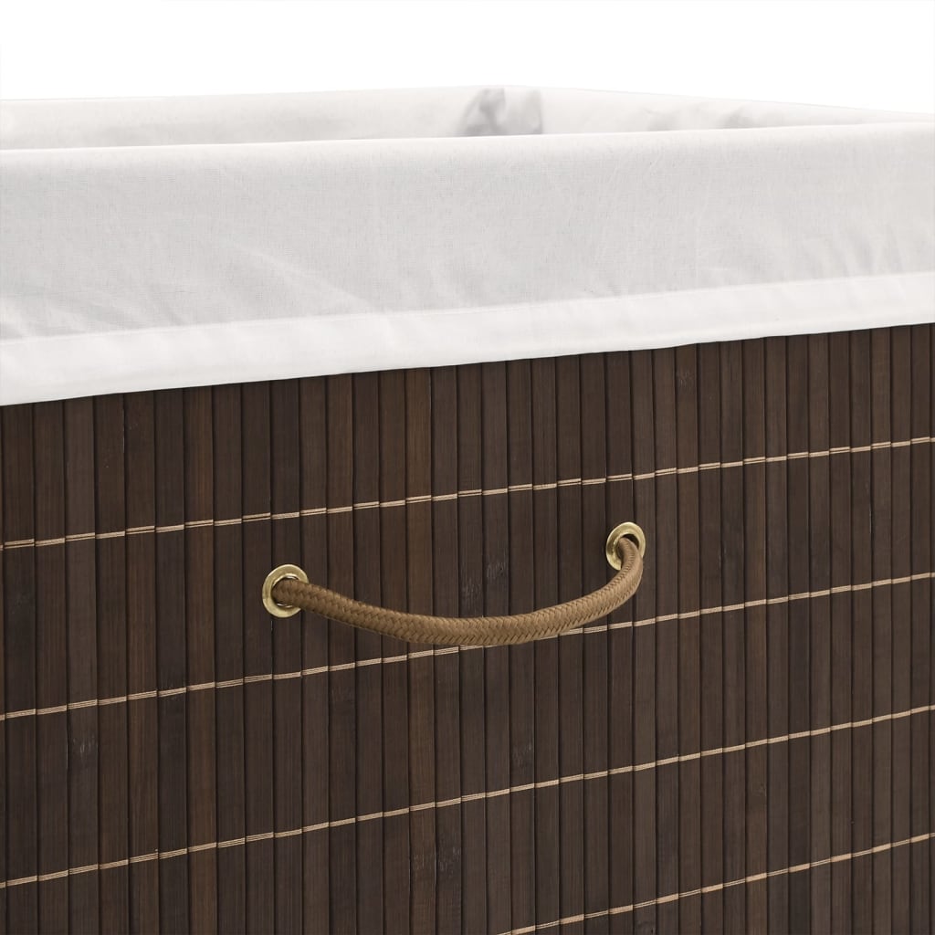 Rectangular dark brown bamboo laundry hamper with leather handles and white liner.