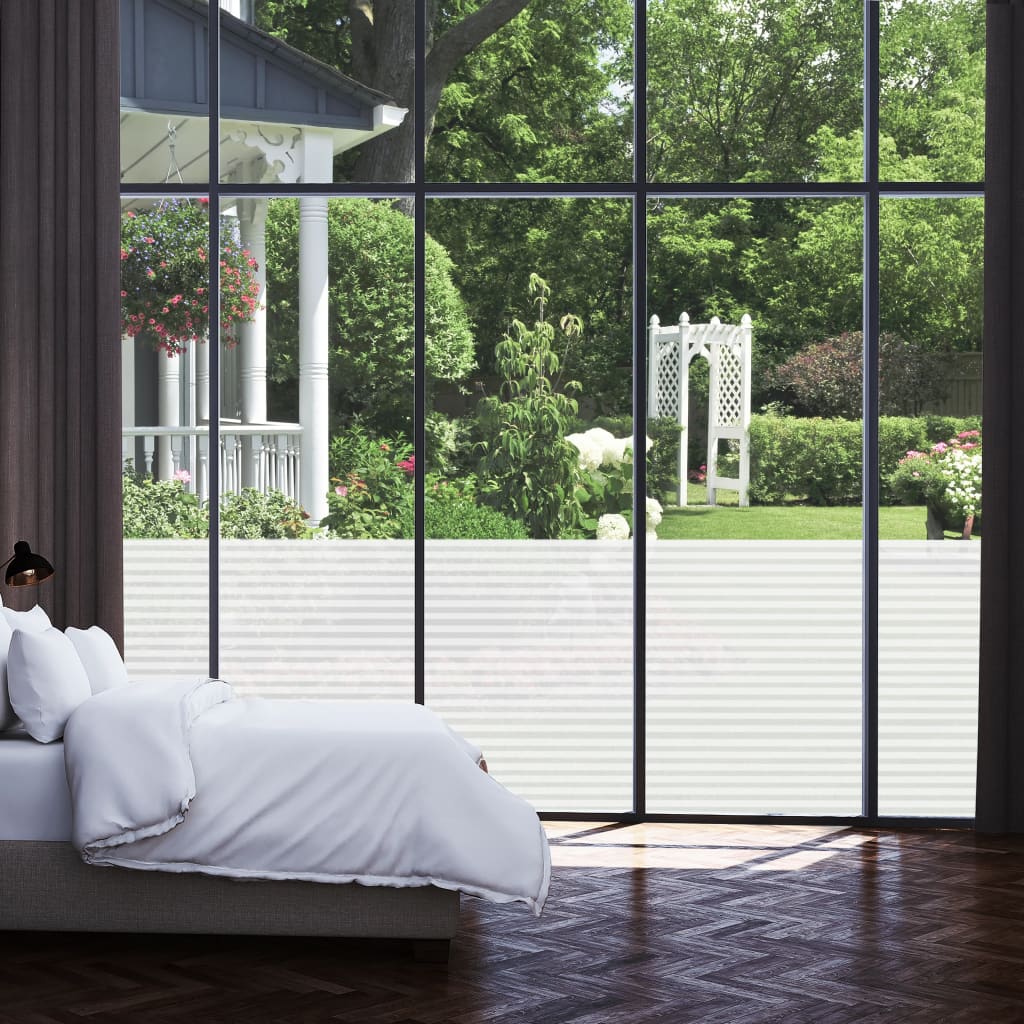 Frosted privacy window film with adhesive stripes applied to large bedroom windows, blurring garden view while allowing light.