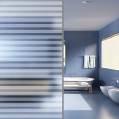 Frosted privacy window film with adhesive blue stripes applied to a modern bathroom window.