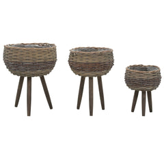 Three brown wicker planters in graduated sizes on wooden legs, with PE lining.