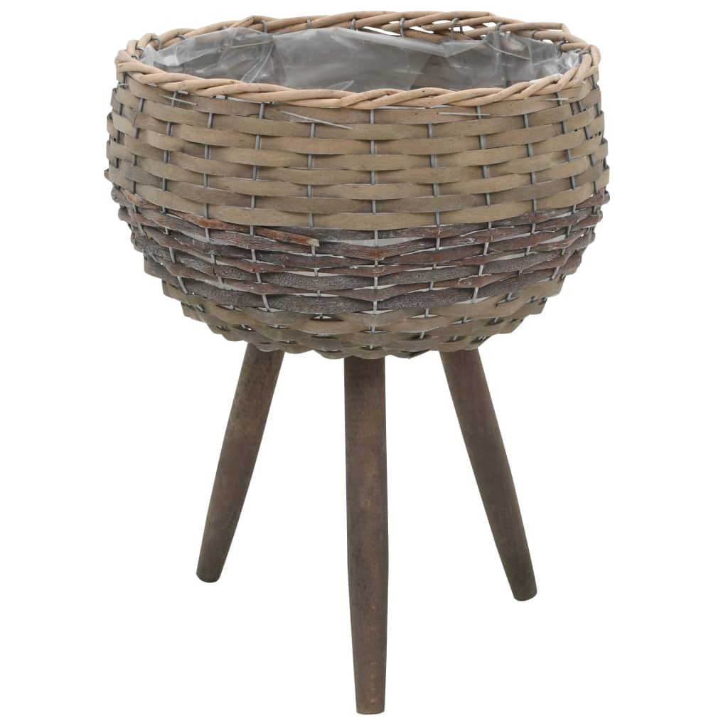 Brown wicker planter on wooden tripod legs with PE lining.
