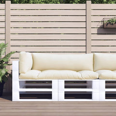 Three sand-colored polyester cushions on a white pallet sofa against a wooden fence.