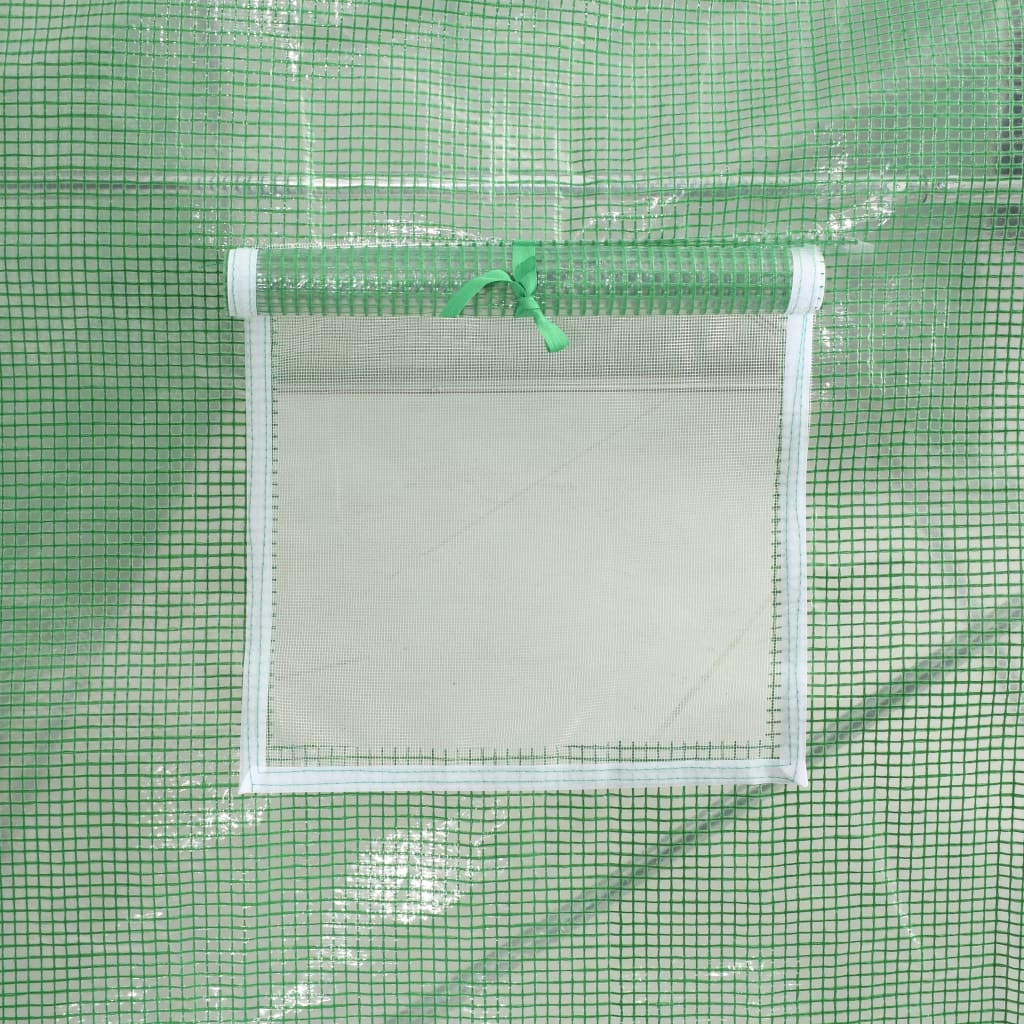 Close-up of a clear window with green ribbon on the green PE mesh fabric of a greenhouse.