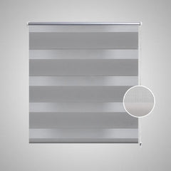 Gray zebra roller blind with alternating sheer and opaque polyester stripes and white pull chain.