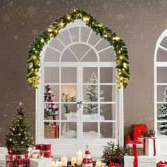 65.6-foot green Christmas garland with LED lights draped over a white arched window.