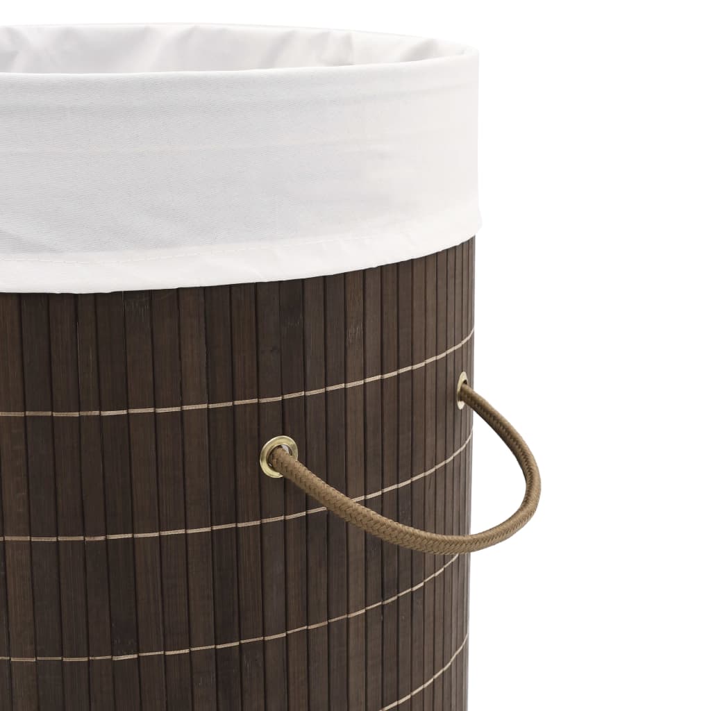 Dark brown round bamboo laundry hamper with removable liner and sturdy handles.