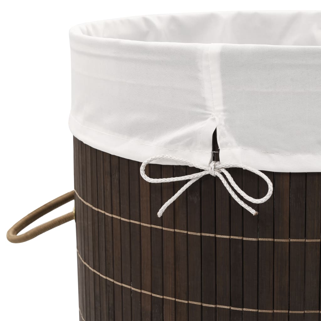 Dark brown round bamboo laundry hamper with removable liner and sturdy handles.