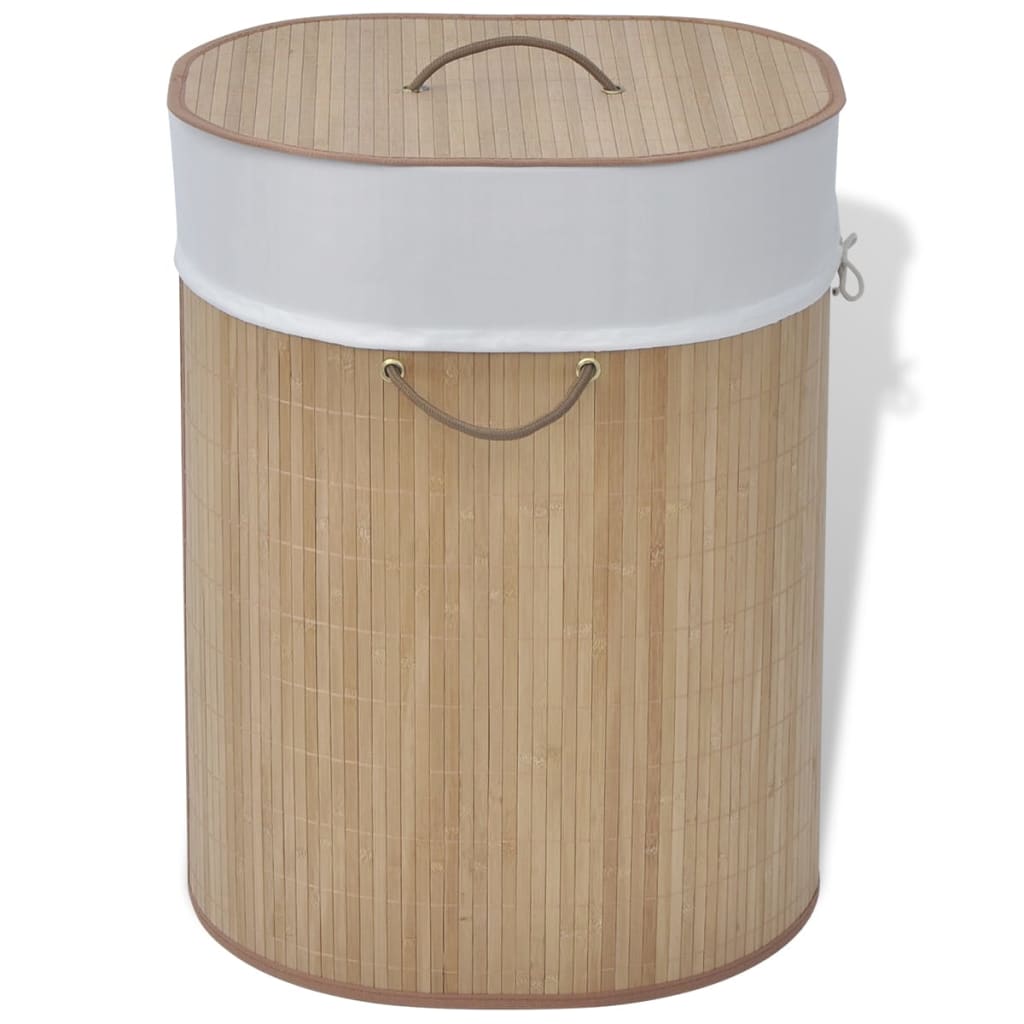 Oval natural bamboo laundry hamper with white liner and leather handles.