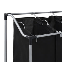 A black steel laundry sorter with three removable black fabric bags hanging from a top bar.
