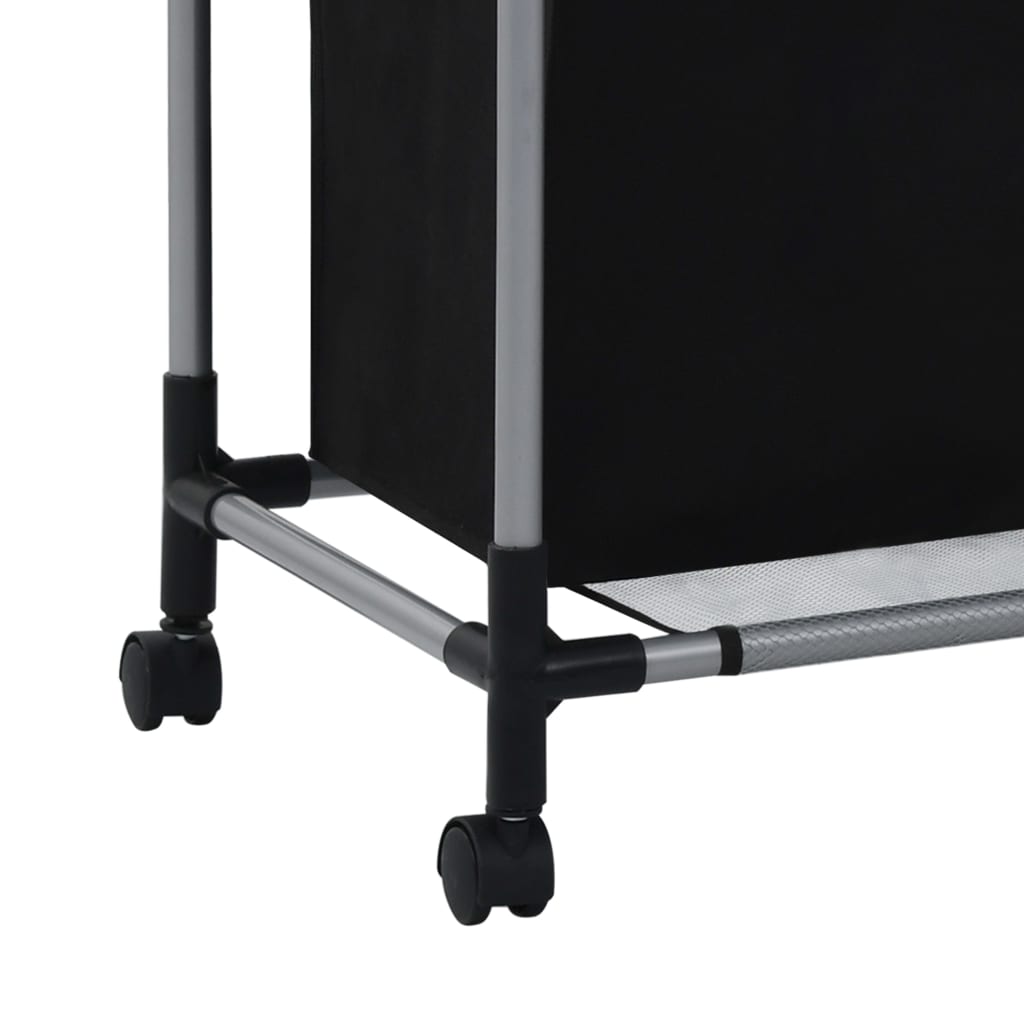 A close-up of the bottom of a black steel laundry sorter with wheels.