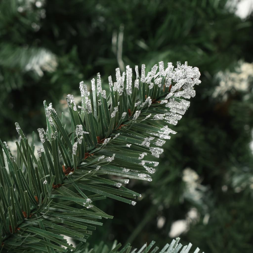 Close-up of artificial pine branches with white glitter and pine cones on a 5 ft Christmas tree.