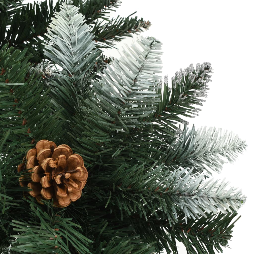 A 6ft artificial Christmas tree with green branches, white glitter, and attached pine cones.