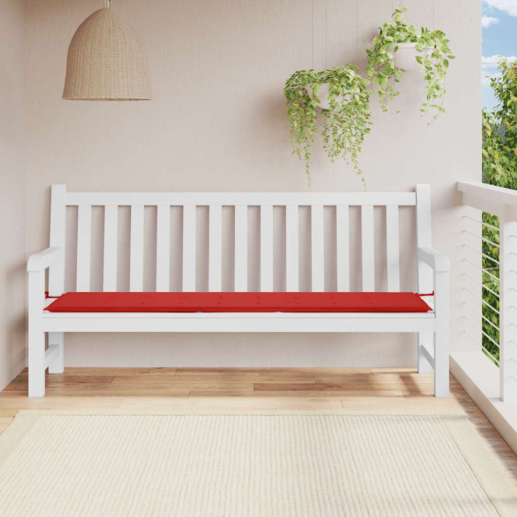 Red Oxford fabric garden bench cushion on white wooden bench in outdoor setting.