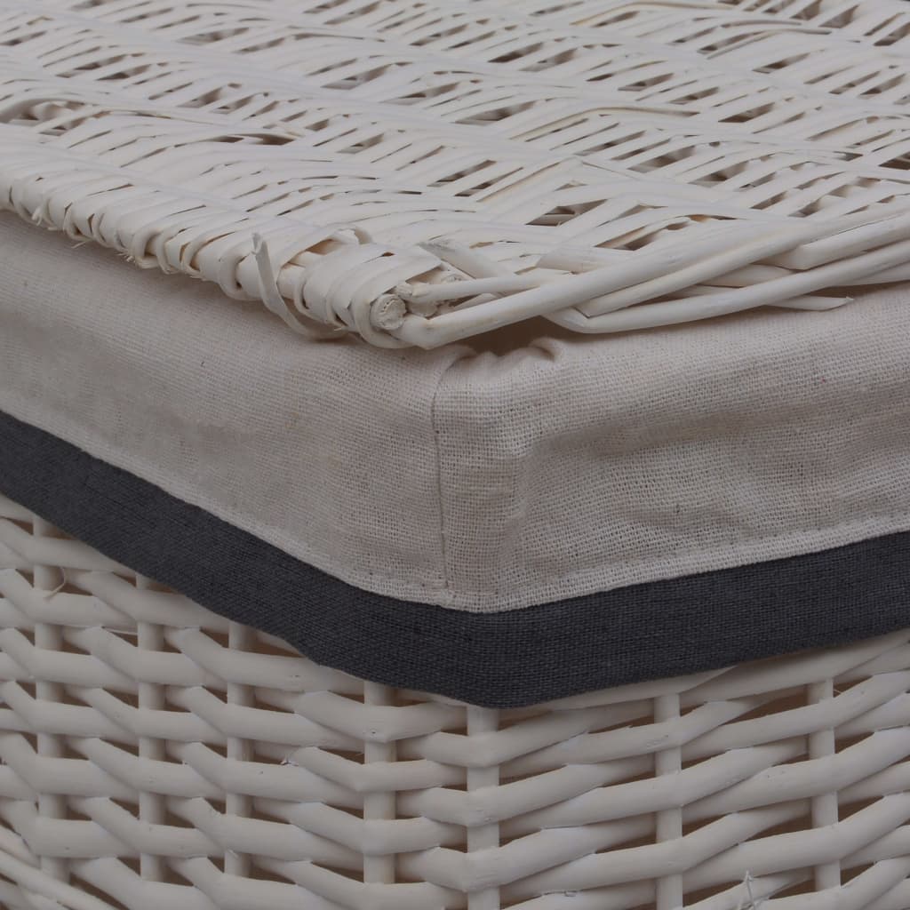 White woven willow laundry basket with beige linen liner and dark trim.