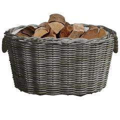 Gray woven willow firewood basket with handles, filled with wood logs.