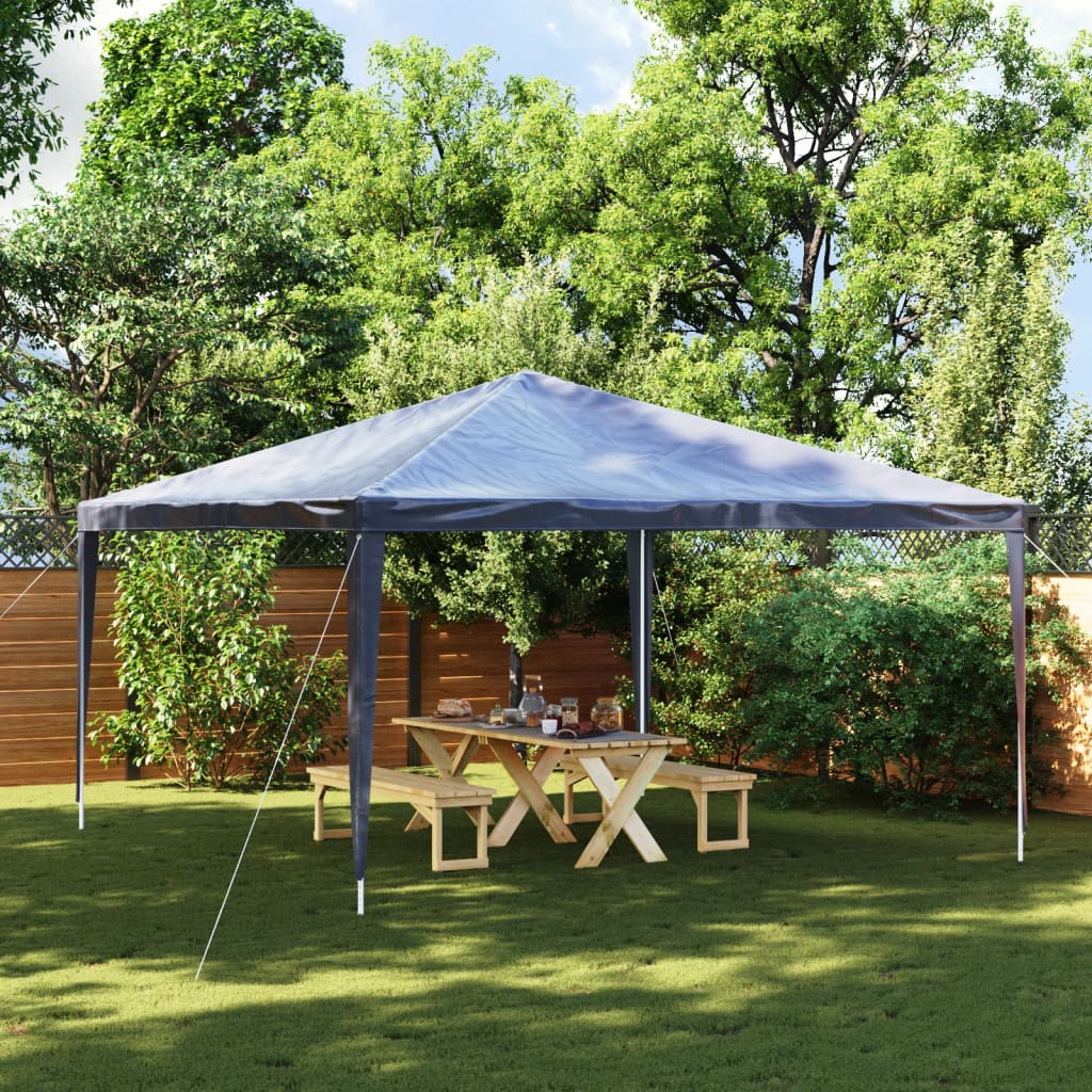 A blue 13.1x13.1 ft party tent with UV water-resistant canopy set up in a backyard over a wooden picnic table.