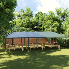 Green 13.1'x29.5' party tent with UV water-resistant PE canopy over wooden picnic tables in a backyard.