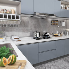 Gray self-adhesive PVC film applied to modern kitchen cabinets and surfaces.