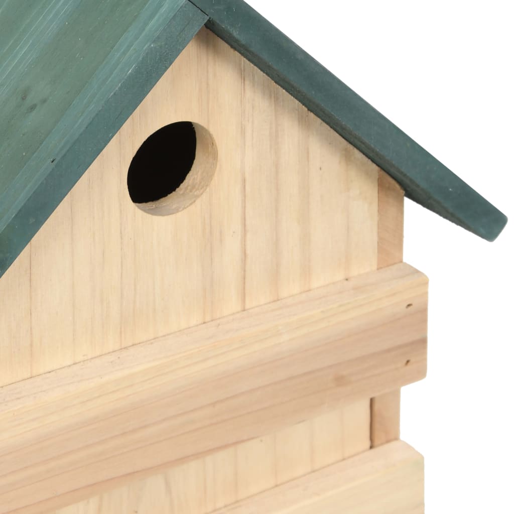Wooden bird house with green roof and entry hole, made of firwood.