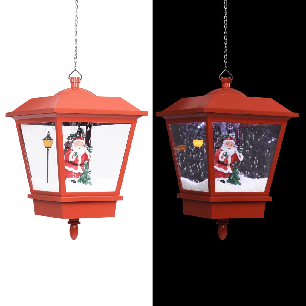 Red hanging Christmas lantern with LED lights, Santa, and swirling snow inside, suspended by chain.