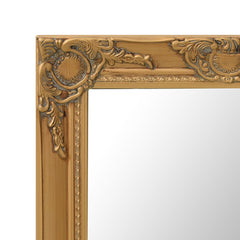 A close-up of the ornate gold frame of a rectangular wall mirror.