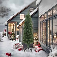 An 8-foot slim green PVC artificial Christmas tree on a metal stand, displayed outdoors in a snowy winter scene with houses and decorations.
