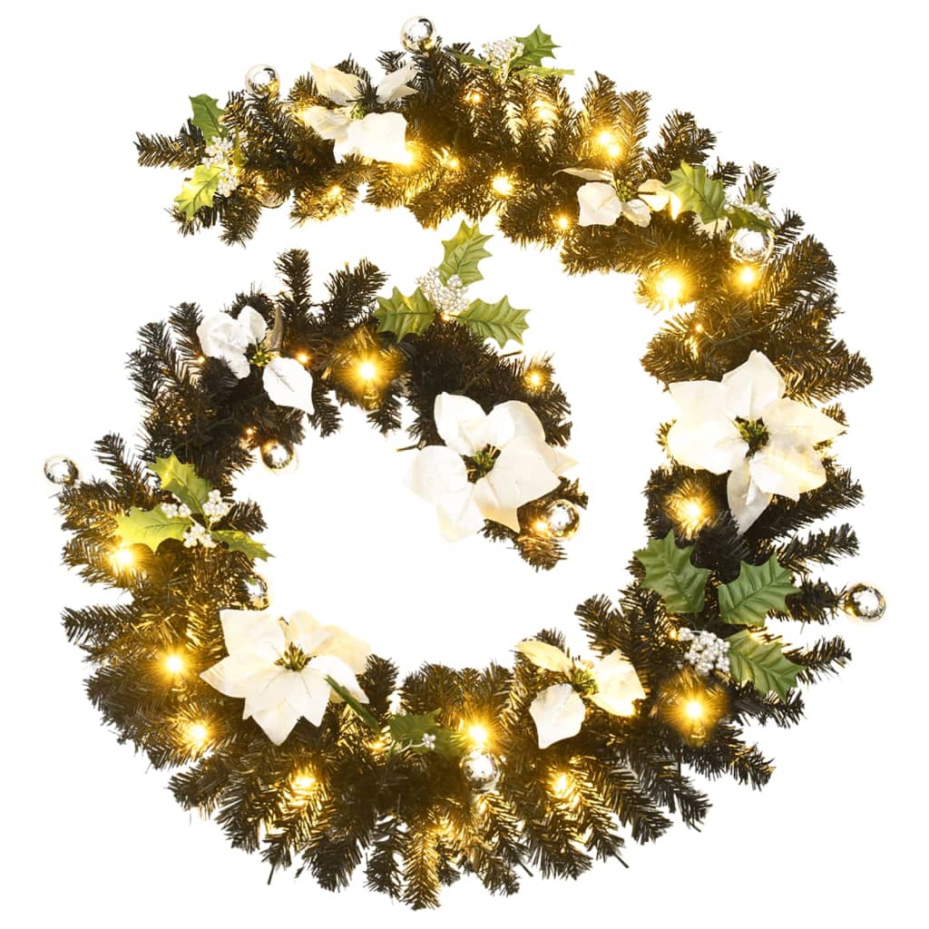 Black PVC Christmas garland with white poinsettias, holly, and warm LED lights, 8.9 feet long.