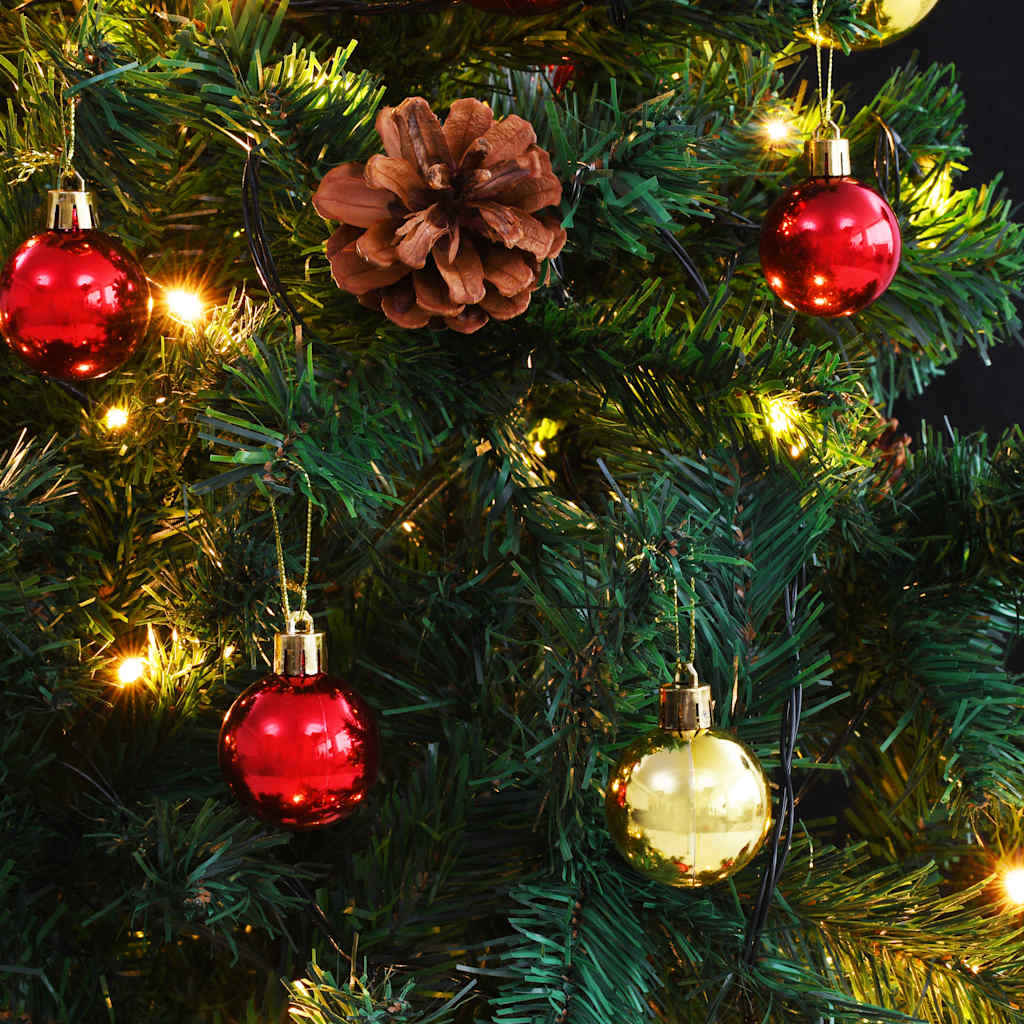 A 7ft pre-lit artificial Christmas tree with green branches, red and gold baubles, pinecones, and twinkling LED lights.