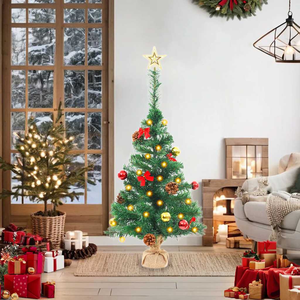 A 2ft pre-lit artificial Christmas tree in green with baubles, star topper, and warm LED lights.