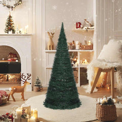 A 7ft green PVC pop-up pre-lit artificial Christmas tree displayed in a festive living room.
