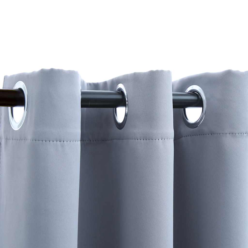 Two gray blackout curtain panels with rings, sized 37x84 inches, hung on a rod.