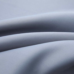 Two gray blackout curtain panels, 54x84 inches each, with metal rings.