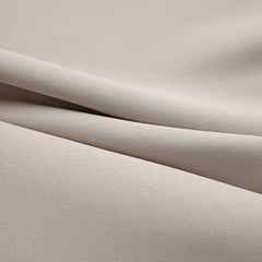 Two beige blackout curtain panels, 37x63 inches each, with metal rings.