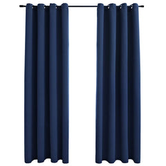 Two navy blue blackout curtain panels with grommets are hanging on a black rod.