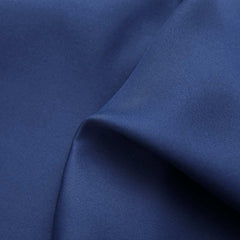 Close-up of navy blue blackout curtain fabric with subtle texture and folds.