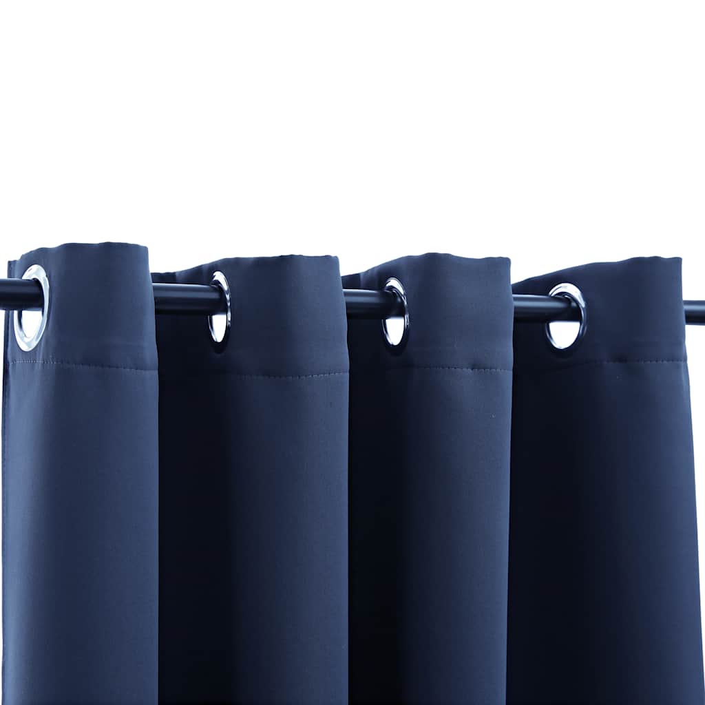 Two navy blue blackout curtains with grommet rings, each 54x95 inches, hung on a rod.